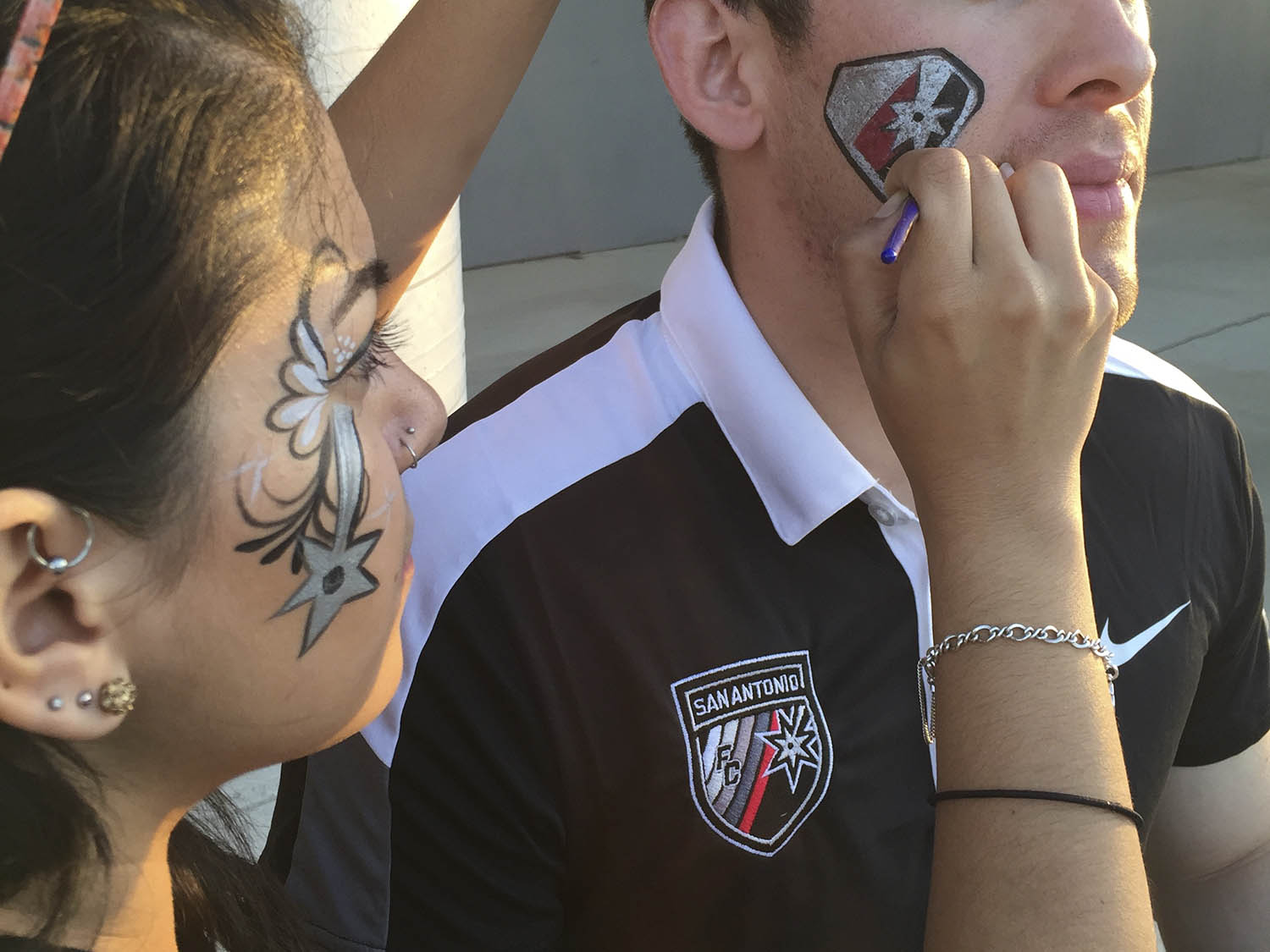 Face painters painting at a festival