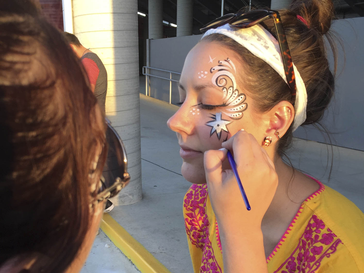 Artist applying custom face paint.