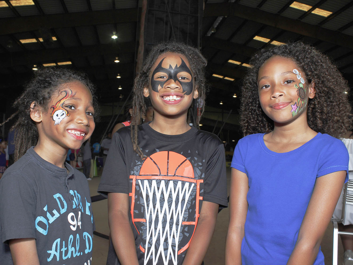 Three children with face paints.